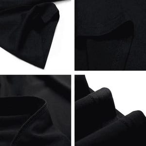 Pode incluir: Close-up de uma camiseta preta, mostrando a textura do tecido e os detalhes da costura. A imagem destaca a gola, o ombro e a bainha, enfatizando a constru&ccedil;&atilde;o da pe&ccedil;a de roupa. A cor escura sugere uma pe&ccedil;a de vestu&aacute;rio vers&aacute;til.