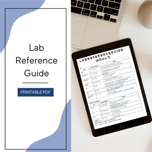 May include: A digital tablet displaying a Lab Reference Guide for adults, featuring a table with lab values, normal ranges, and notes. The screen shows sections for CBC and Iron Studies. Next to the tablet is a partial view of a laptop keyboard.