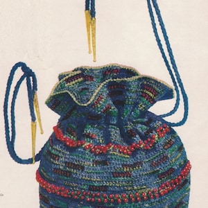 May include: A blue crocheted drawstring bag with red beads and yellow tassels. The bag has a ruffled top and is made with a variety of stitches.