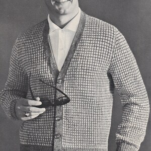 May include: A gray and white cardigan with a button-up front. The cardigan has a waffle knit texture and is worn over a white collared shirt.