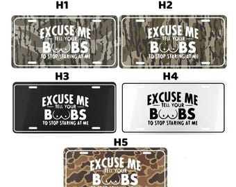 May include: License plates with the text "Excuse Me Tell Your Boobs To Stop Staring At Me." The plates have different backgrounds, including camouflage, black, and white. The text is in a bold, sans-serif font.