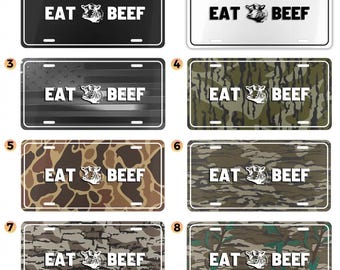 May include: License plates with the text "EAT BEEF" and a graphic of a cow's head. The plates come in various designs, including black, white, camouflage, and a design with the American flag.