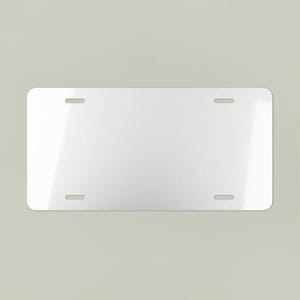 May include: A blank, rectangular license plate with rounded corners. The plate is white with four evenly spaced mounting holes. The surface has a slight sheen, reflecting ambient light.