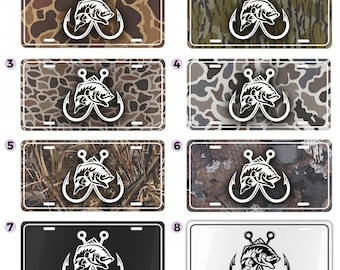 May include: Rectangular license plates with a fishing theme. The plates feature a white graphic of a fish and hook design. The backgrounds vary, including camouflage patterns in shades of brown, green, and gray, as well as solid black and white options.