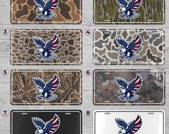 May include: License plates with an American eagle design. The plates feature a patriotic eagle with blue, red, and white colors. The backgrounds vary, including camouflage patterns in brown, green, and gray, as well as solid black and white options.