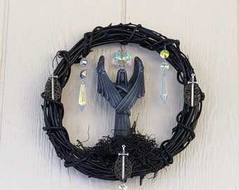 10" Black wreath featuring Templar Angel surrounded by crystals.  Makes for great addition to mystic, sacred space or even Halloween decor.