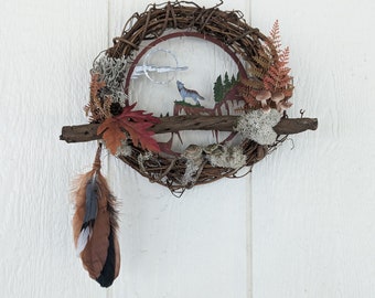 Fall themed wreath with howling wolf and pine tree scene.