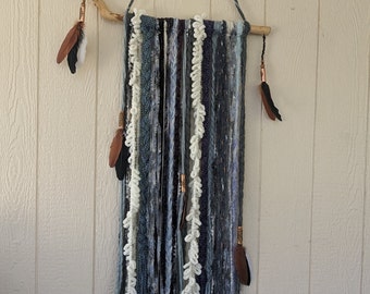 Driftwood and yarn wall hanging 28" x 77" with decorative copper tube beads and multi-colored feathers.