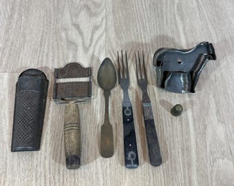 Antique items: 2 graters, 2 forks, 1 spoon, cookie cutter, thimble.