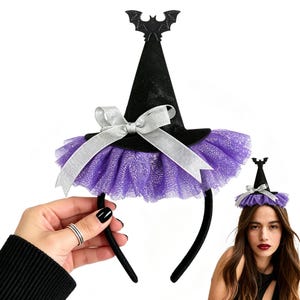 May include: A black headband featuring a miniature witch hat with a pointed top, a purple tulle ruffle at the base, a silver ribbon bow, and a small black bat silhouette attached to the peak of the hat. The accessory is designed for head wear.
