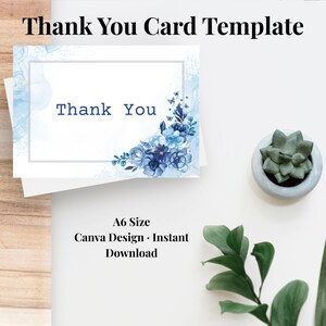May include: A rectangular thank you card template featuring a white background with a blue watercolor wash, a gray border, and a cluster of blue flowers and butterflies in the corner. The text Thank You is printed in blue. A6 size is indicated.