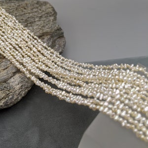 Japanese Keshi Pearls, Akoya Natural Color Off-White with Champagne AAA Saltwater Pearls 12 Strand Lot 15.5 Inches Per Strand PearlExporting