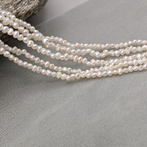 Smaller Keshi Pearls - Japanese Akoya Side Drilled Natural Color Saltwater Keshi - Off White Light Silver 15.5 Inches Strand PearlExporting