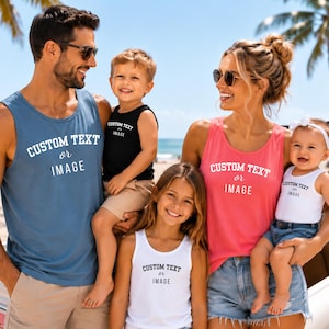 May include: A collection of sleeveless tank tops in blue, black, pink, and white, each featuring the printed text CUSTOM TEXT or IMAGE. These garments are designed for casual wear and display a consistent graphic layout across all four pieces.
