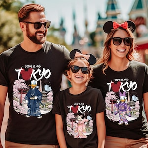 May include: Black t-shirts with a Disneyland Tokyo design. The shirts feature Donald Duck, Minnie Mouse, and Daisy Duck in traditional Japanese attire, with cherry blossoms and a pagoda. The text "Disneyland Tokyo" is displayed.