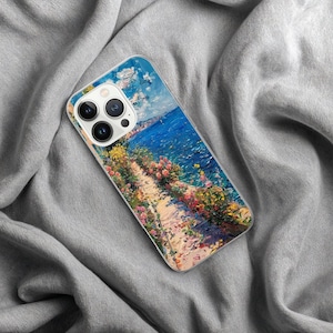 May include: A phone case featuring a vibrant impressionist painting of a coastal scene. The artwork depicts a path lined with colorful flowers overlooking a bright blue sea under a cloudy sky. The case is made of clear plastic.