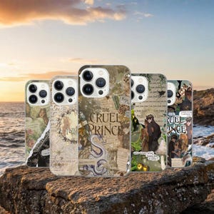 May include: A collection of phone cases with various designs. The cases feature illustrations, text, and a collage aesthetic. One case displays "The Cruel Prince" text with a dragon illustration. Other cases have floral and character art.