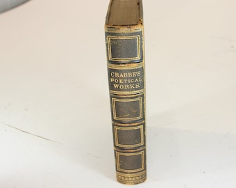 May include: A vintage book titled "Crabbe's Poetical Works" with a dark cover and gold lettering. The spine features decorative rectangular panels. The book's edges show signs of wear, indicating its age.