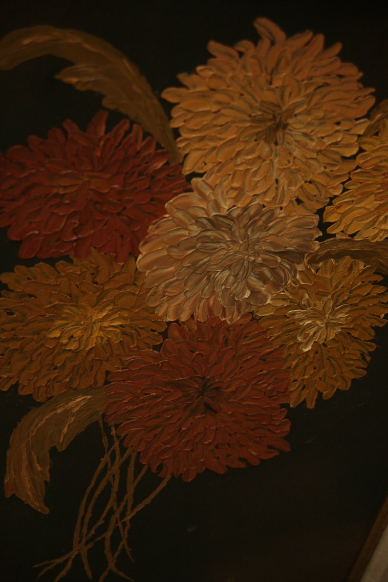 May include: Close-up of a painting featuring a cluster of textured flowers in shades of orange, yellow, and red against a dark background. The brushstrokes are visible, creating a three-dimensional effect.