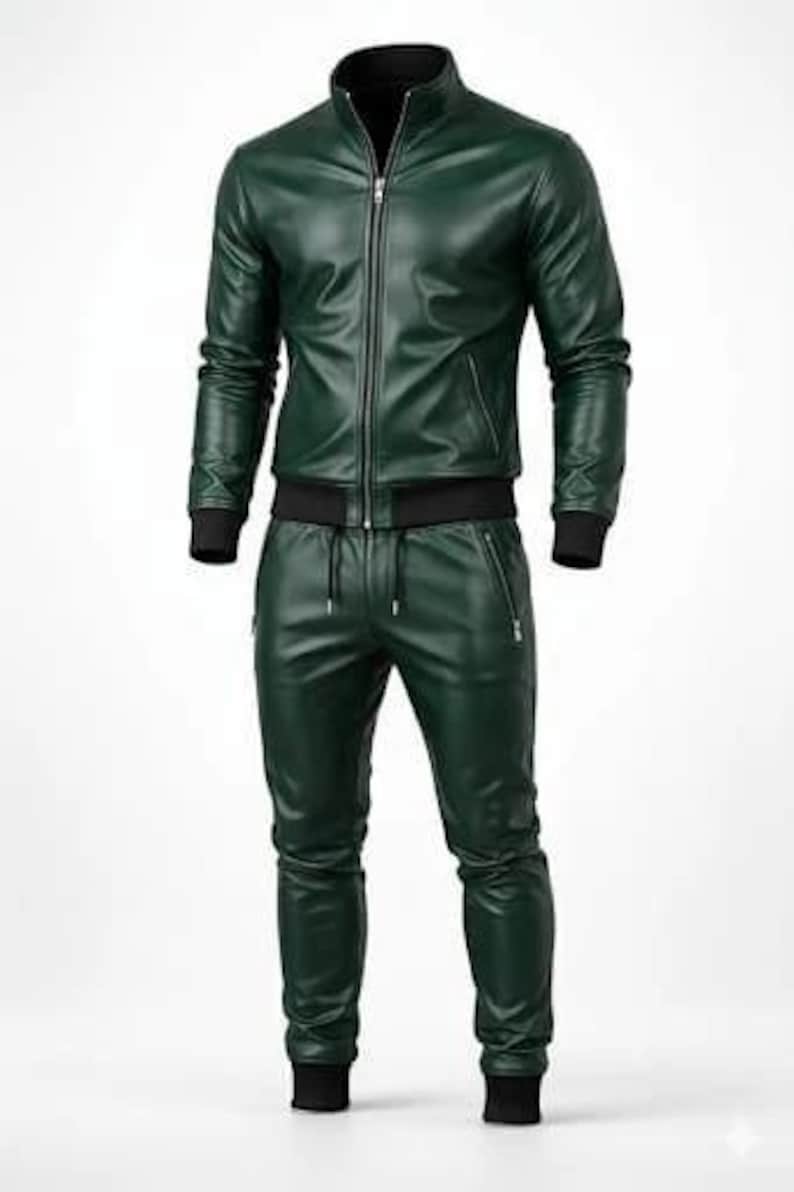 May include: A dark green leather tracksuit. The jacket has a zip-up front, a stand-up collar, and black ribbed cuffs and hem. The pants have a drawstring waist and zippered pockets, with black ribbed cuffs at the ankles.