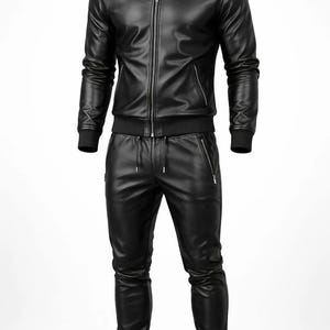 May include: A black leather jacket and matching pants set. The jacket features a zip-up front, a stand-up collar, and ribbed cuffs and hem. The pants have a drawstring waist and zippered pockets. The outfit is made of a shiny, smooth material.