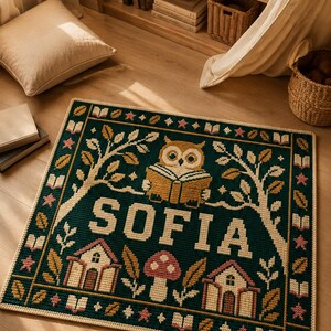 May include: A rectangular dark green rug featuring a central cream-colored name SOFIA, an owl reading a book, two small houses, and a mushroom. The border displays a repeating pattern of books, stars, and leaves in cream, yellow, and pink tones.