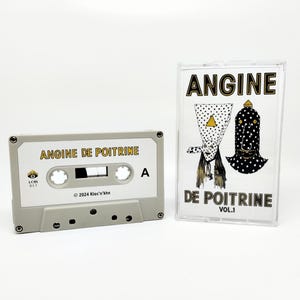 May include: A white ceramic mug with a black handle and the text "But First, Coffee" in a bold, black font. The mug is set against a blurred background, suggesting a cozy setting.