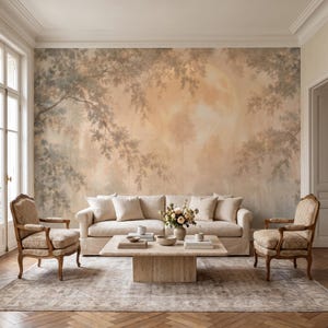 May include: A large-scale wall mural featuring a soft, hazy forest landscape in muted peach and grey tones, depicting silhouetted tree branches framing a large, glowing moon. The mural covers the entire wall behind a beige sofa and two chairs.