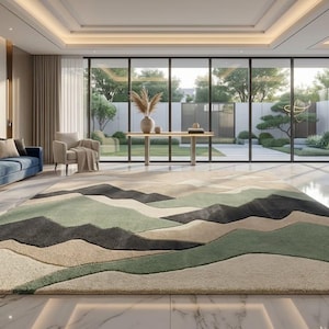 May include: A large, rectangular area rug with a mountain landscape design in shades of green, black, and beige dominates the room. The rug sits on a marble floor in a modern living space with a blue sofa and large windows.