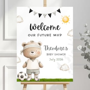 Puede incluir: Un letrero de bienvenida para baby shower con un oso de dibujos animados con uniforme de fútbol. El letrero dice "Welcome Our Future MVP" y "Theodore's Baby Shower July 2026". El diseño incluye ilustraciones de balones de fútbol y sol.