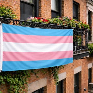 May include: A white ceramic mug with a black handle and the text "But First, Coffee" in a black, bold font. The mug is sitting on a white surface. The mug is approximately 4 inches tall.