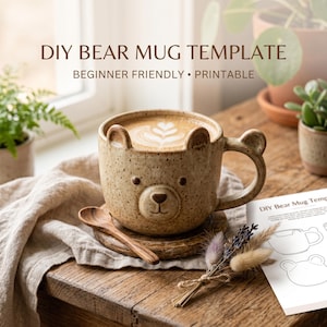 May include: A speckled ceramic bear mug filled with coffee, featuring bear ears and face details. The mug sits on a wooden coaster with a small wooden spoon. Text reads "DIY BEAR MUG TEMPLATE" and "BEGINNER FRIENDLY • PRINTABLE".