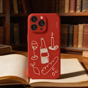 May include: A red phone case featuring a white outline design of wine-related objects: a wine glass, bottle, candle, lemon, and bread. The case has a camera module and the text "TRUNCATE" on the side.