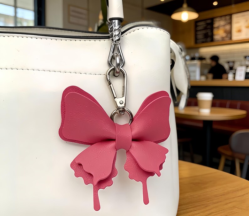 Leather butterfly keychains in multiple colors with gold clasps and cutout wing details, forest decor bag charm accessories.
