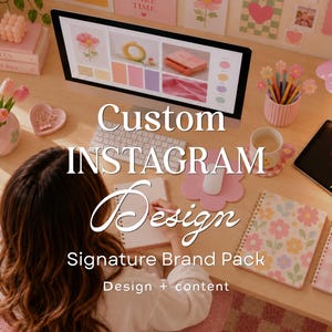 May include: A workspace featuring a computer monitor displaying a design mood board, a white keyboard, a mouse on a flower-shaped pad, two spiral notebooks with floral and gingham patterns, a tablet with a stylus, and a pink desk lamp.