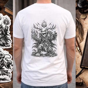 May include: A white t-shirt with a detailed black illustration on the back. Also shown are stickers with fantasy skeleton characters, and a journal with a winged demon illustration. Dice are scattered around.