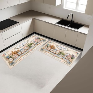 May include: Two rectangular kitchen rugs featuring a cream background with illustrations of a teapot, jars, and flowers. The text "KITCHEN" and "Good Food &bull; Good Mood &bull; Good Life" are printed on the rugs, surrounded by blue and pink floral accents.