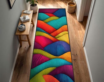 May include: A rectangular hallway rug with a vibrant, abstract design. The rug features a layered pattern of colorful, undulating shapes in shades of red, orange, yellow, green, blue, and purple. The rug is placed on a wooden floor.