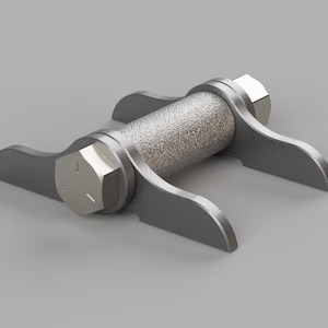 May include: A metallic grey mechanical component. It features a textured cylindrical centre, secured by hexagonal bolts to two curved arms on each side. The object is set against a plain grey background.