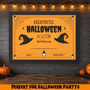 May include: A framed orange Halloween sign with black text and witch hat illustrations. The sign reads "Kreativstes Halloween Kost&uuml;m Verliehen an" and includes space for a date and signature. Pumpkins and candles decorate the scene.