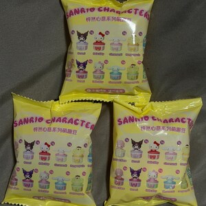 Può includere: Tre sacchetti ciechi gialli di Sanrio Character. Ogni sacchetto presenta una varietà di personaggi Sanrio in un design a cupcake. I sacchetti hanno testo in inglese e cinese. I sacchetti sono sigillati e pronti per essere aperti.