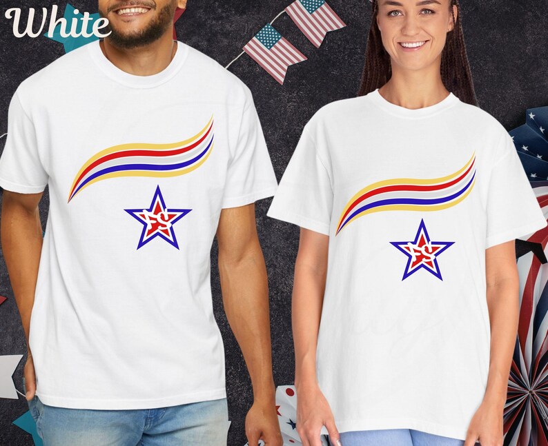 May include: White t-shirts with a patriotic design. Each shirt features a curved design in red, yellow, and blue above a blue star with a red center. The word "White" is visible in the upper left corner.