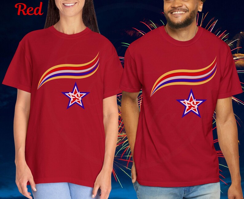 May include: Red t-shirts with a star and wave design. The star is outlined in white and blue, with the letters "SC" inside. A curved wave design in yellow, red, and blue is above the star. The word "Red" is in the top left corner.