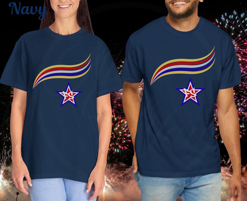 May include: Navy blue t-shirts with a star and ribbon design. The shirts feature a red, white, and gold ribbon design above a star with a red graphic inside. The word "Navy" is visible in the upper left corner.