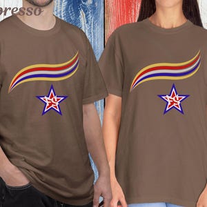 May include: Two brown t-shirts with a star and ribbon design. The star is red and white with a blue outline, and the ribbon is yellow, red, and blue. The word "Espresso" is in the top left corner.