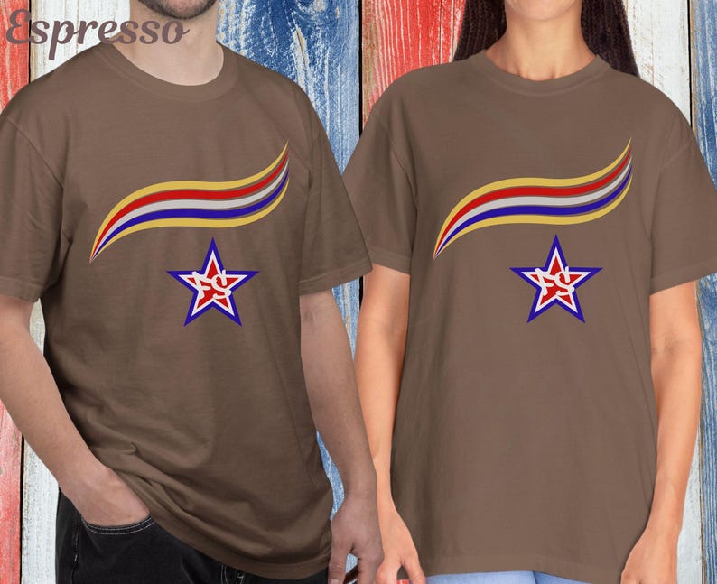 May include: Two brown t-shirts with a star and ribbon design. The star is red and white with a blue outline, and the ribbon is yellow, red, and blue. The word "Espresso" is in the top left corner.