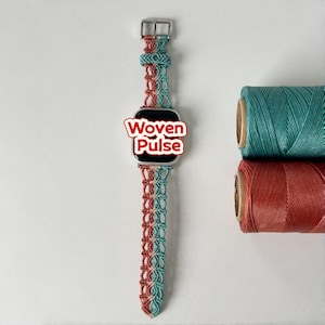 May include: A teal and coral macrame watch strap with a silver buckle. The watch face shows the text "Woven Pulse". Two spools of thread in matching colours are in the background.