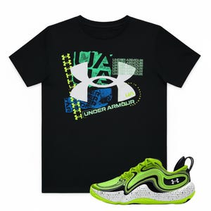 May include: Black Under Armour t-shirt with a large white, blue, and green logo. A pair of neon green and black athletic shoes with white soles are in the foreground. The shoes have the Under Armour logo.