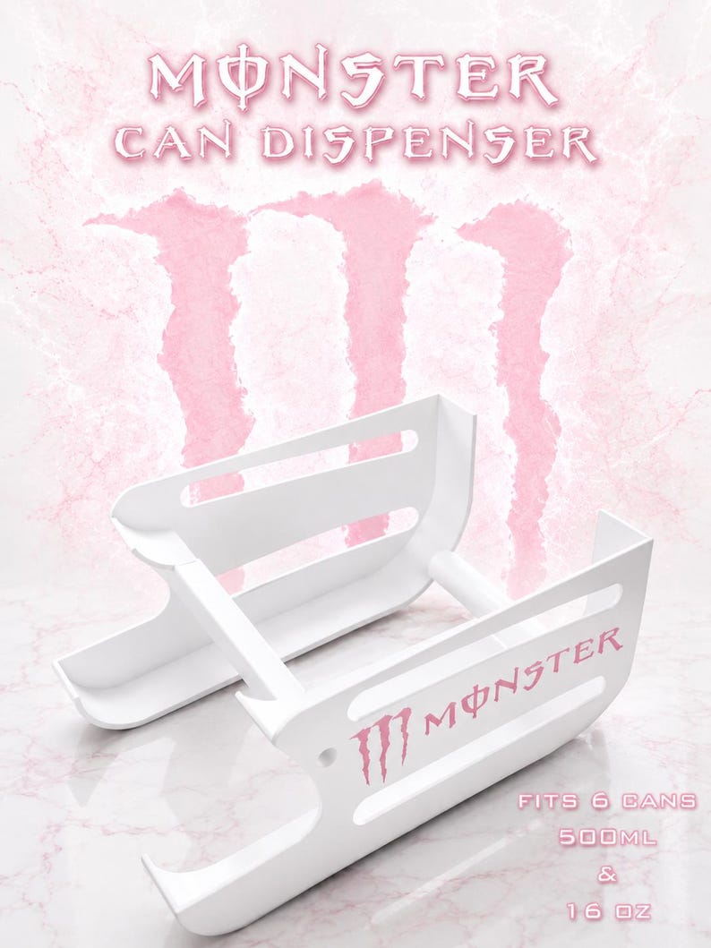 May include: A white plastic can dispenser featuring the Monster logo in pink. The unit is designed to hold 6 cans, with text stating it fits 500ml and 16 oz cans. The structure consists of two parallel side panels connected by horizontal support bars.