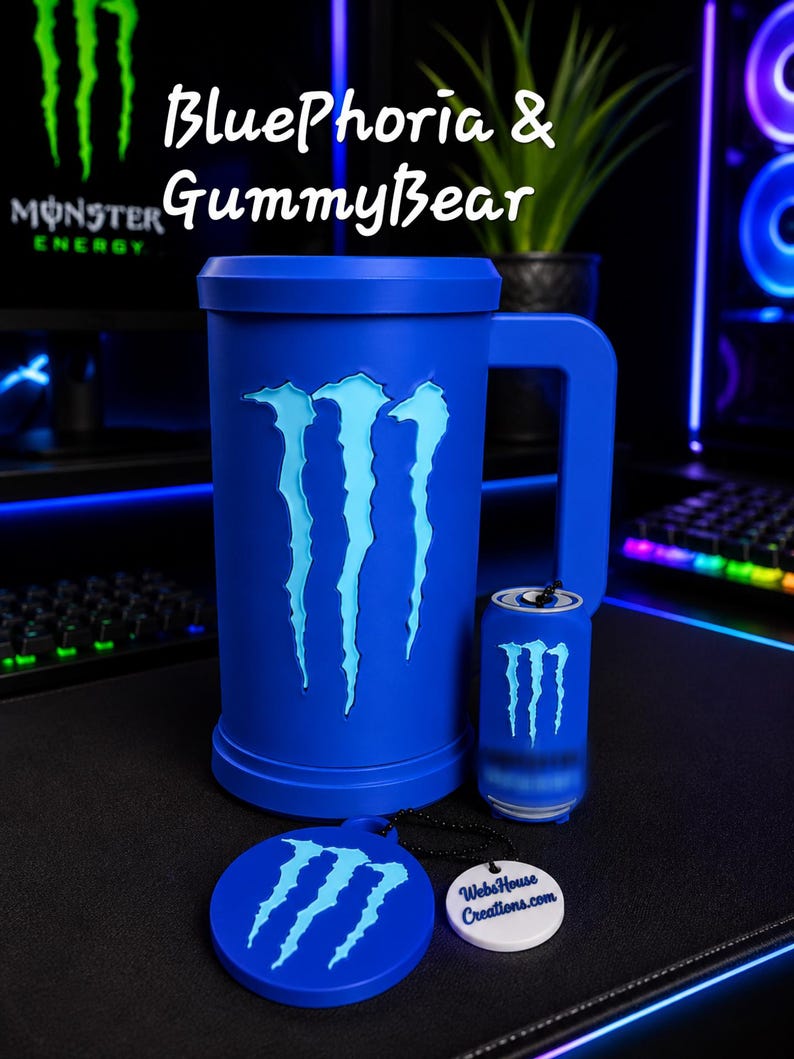 May include: A blue mug featuring the Monster Energy logo, a small blue can-shaped keychain with the same logo, and a round blue coaster with the logo and a white tag reading WebsHouse Creations.com. Text above reads BluePhoria & GummyBear.
